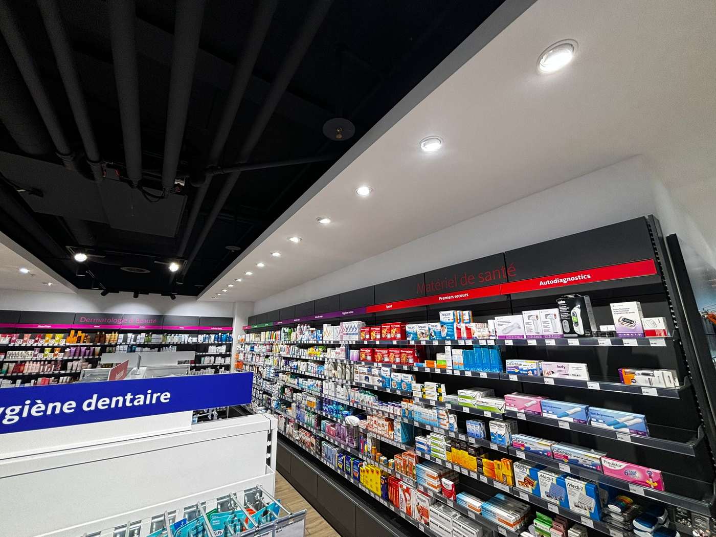 Rayonnages et éclairage terminés dans une pharmacie aménagée à Genève
